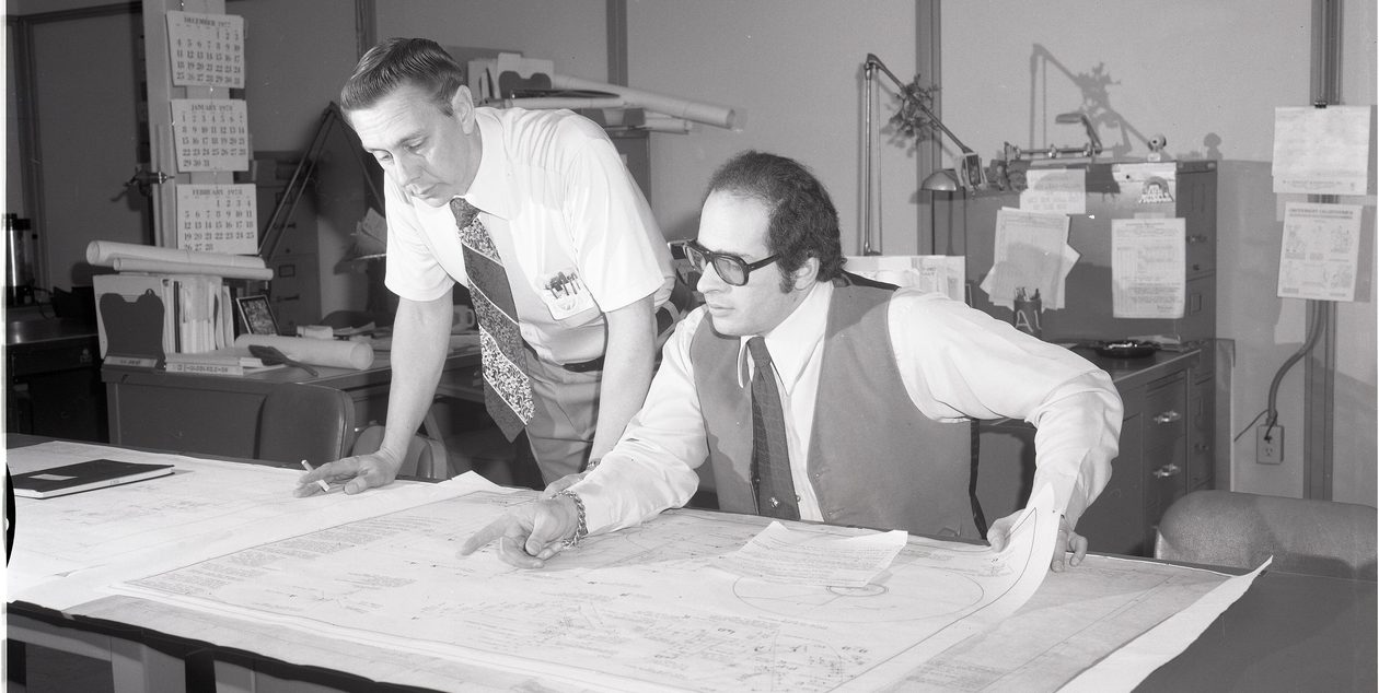 Engineers reviewing a technical drawing in the design office