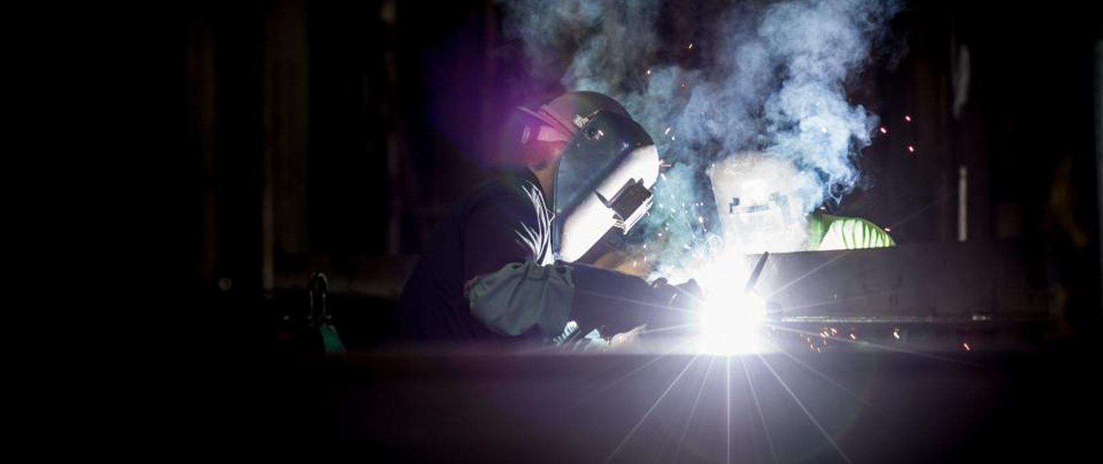 Engineer inspecting process machinery on the manufacturing floor